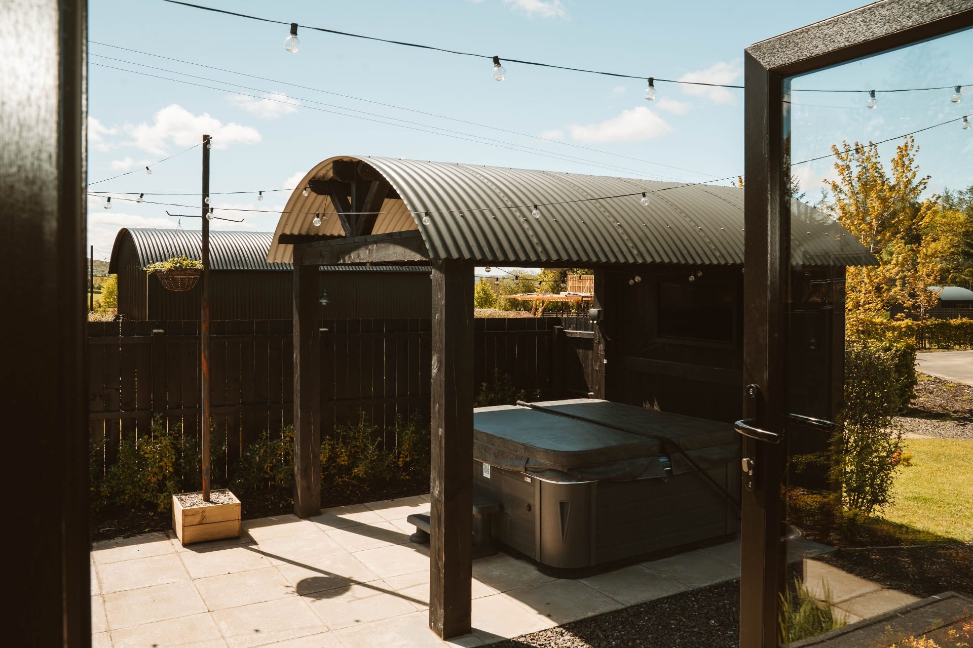 Private Shepherd's Hut hot tub under the pergola