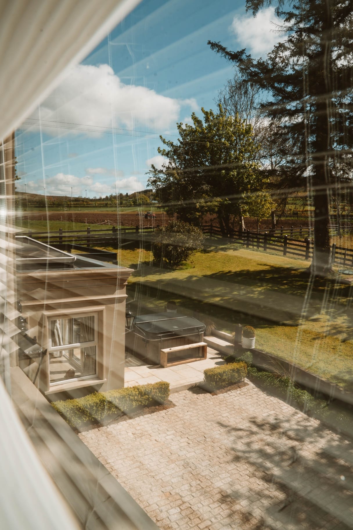 Farmhouse patio, hot tub and paddock view through the window