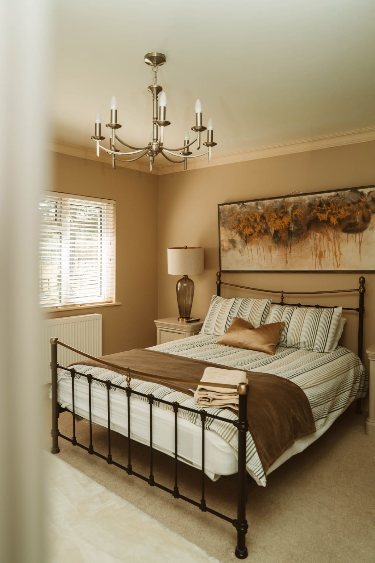 Farmhouse double bedroom with striped linens