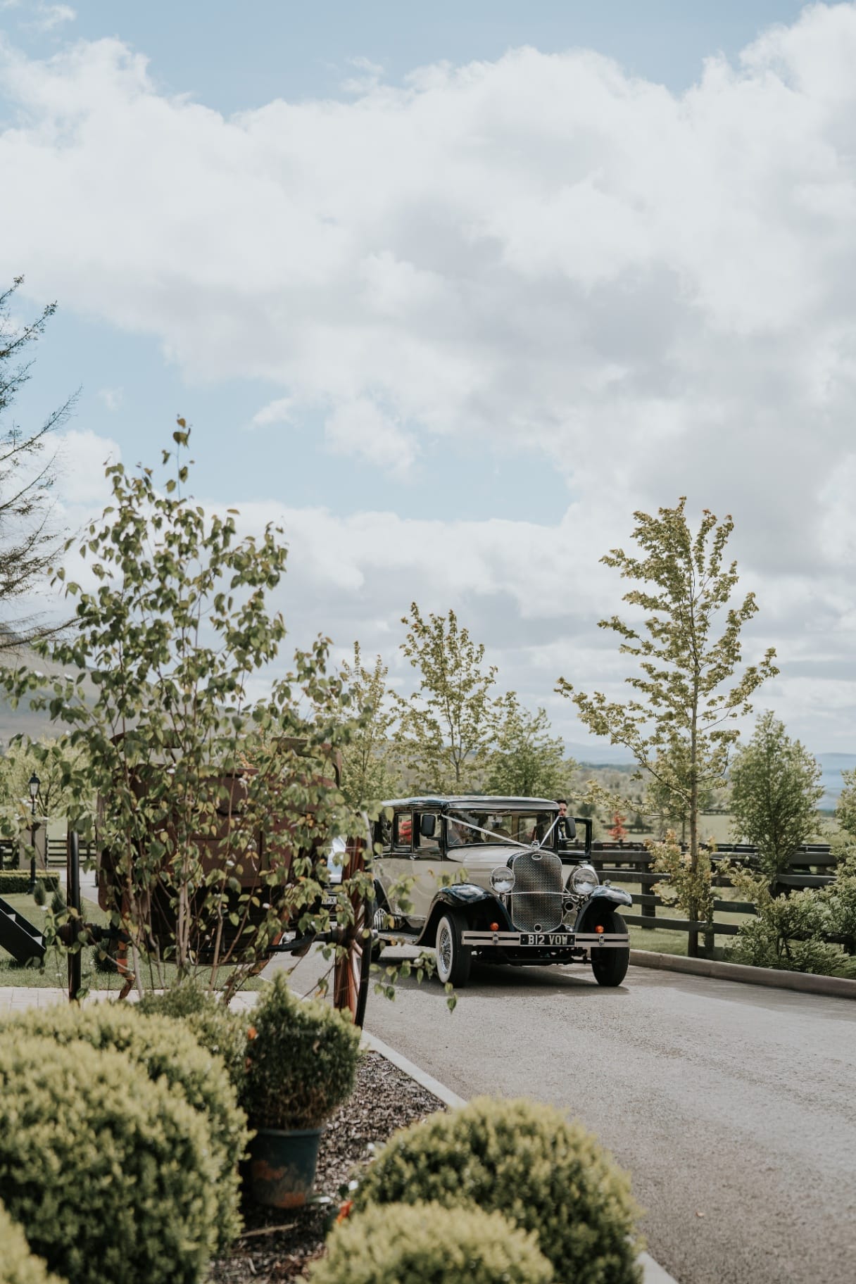 Vintage wedding car arriving along the Ballyness driveway