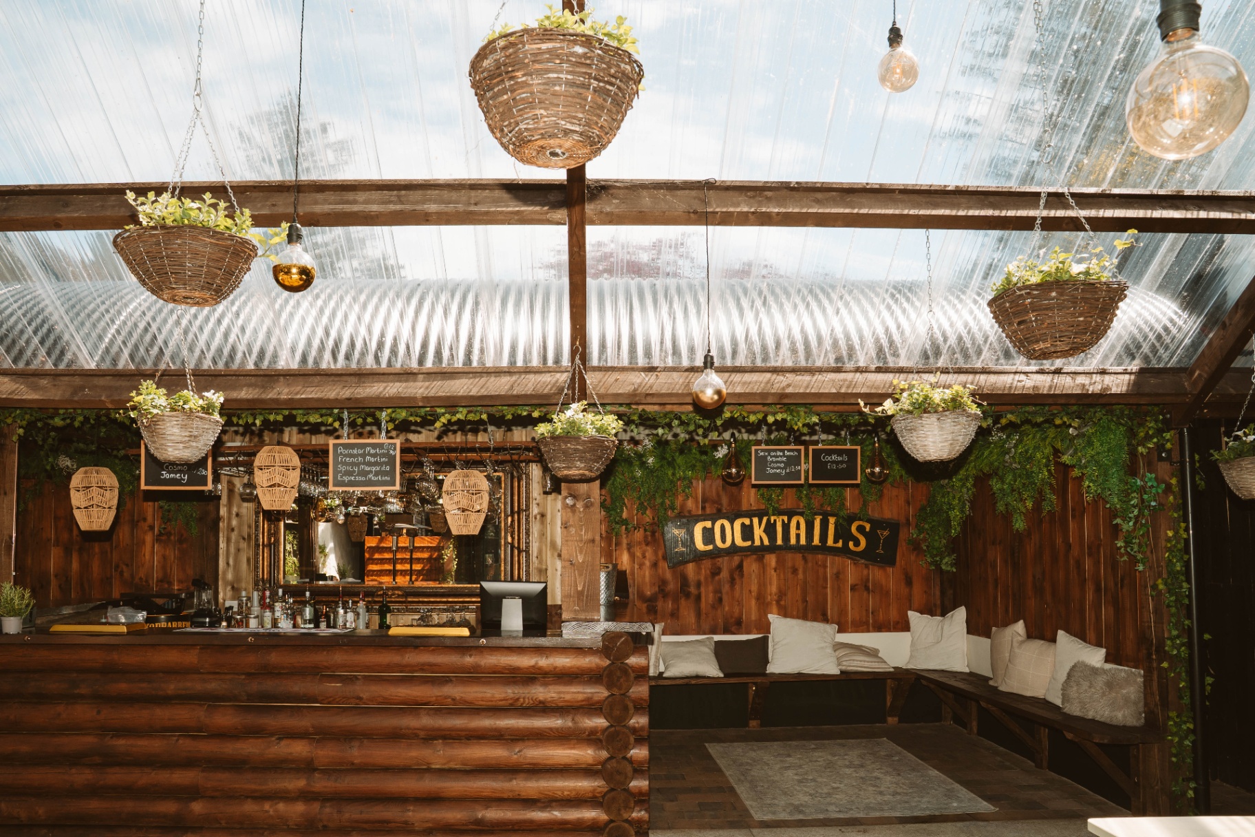 The Stable cocktail bar with log-clad counter and cushioned bench seating