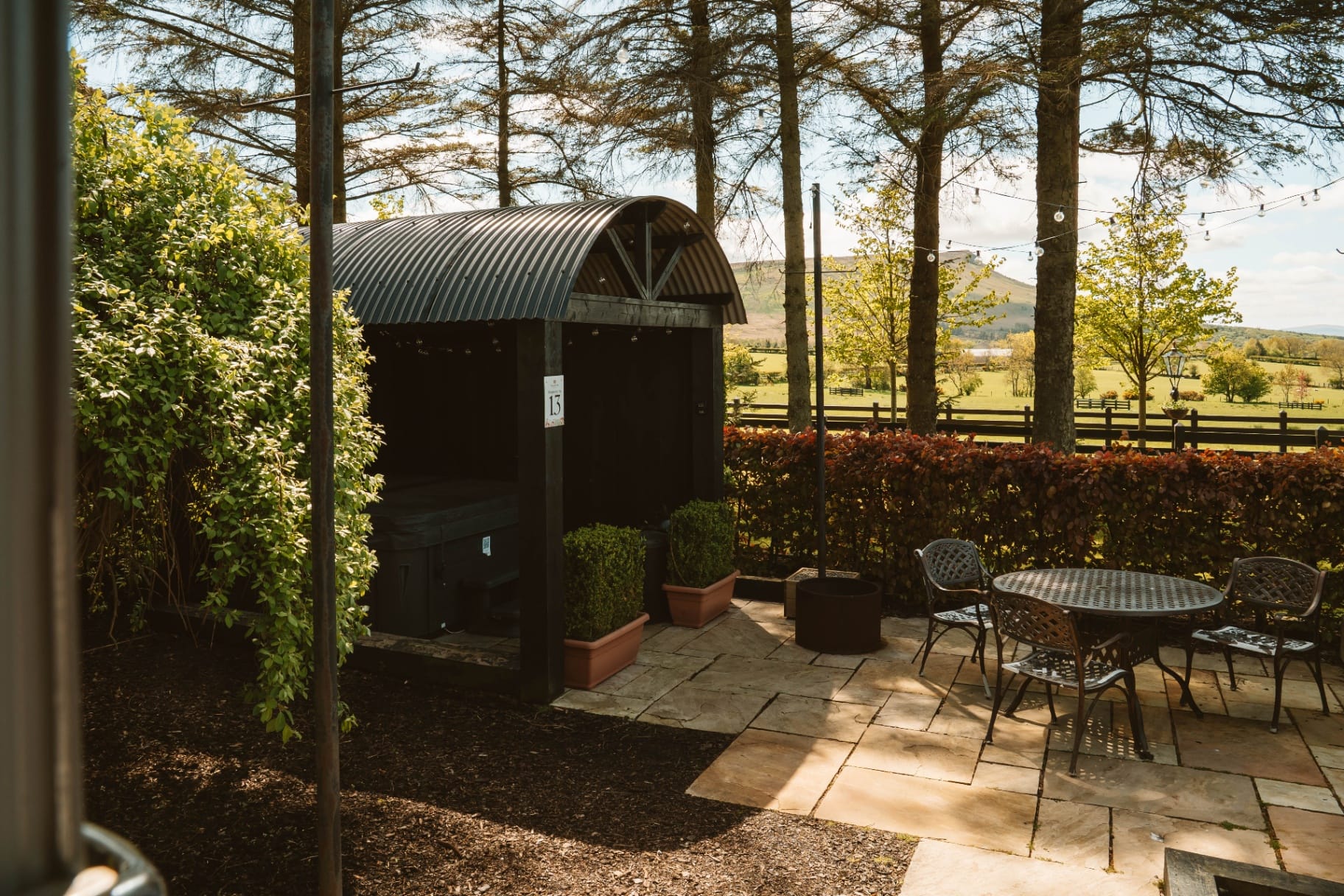 Shepherd's Hut hot tub shelter and patio with mountain view