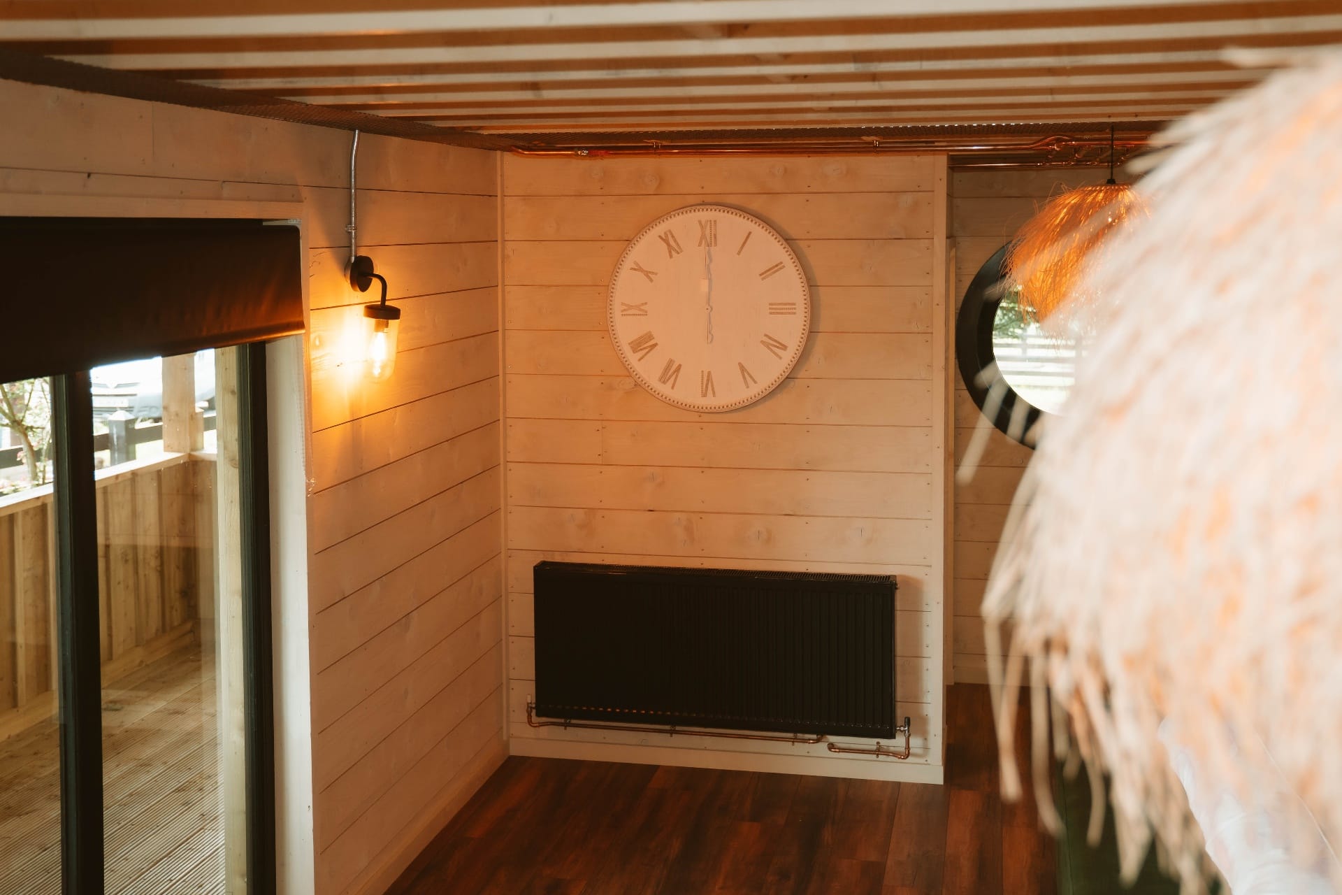 Treehouse Lookout interior with Roman numeral clock, radiator and deck door