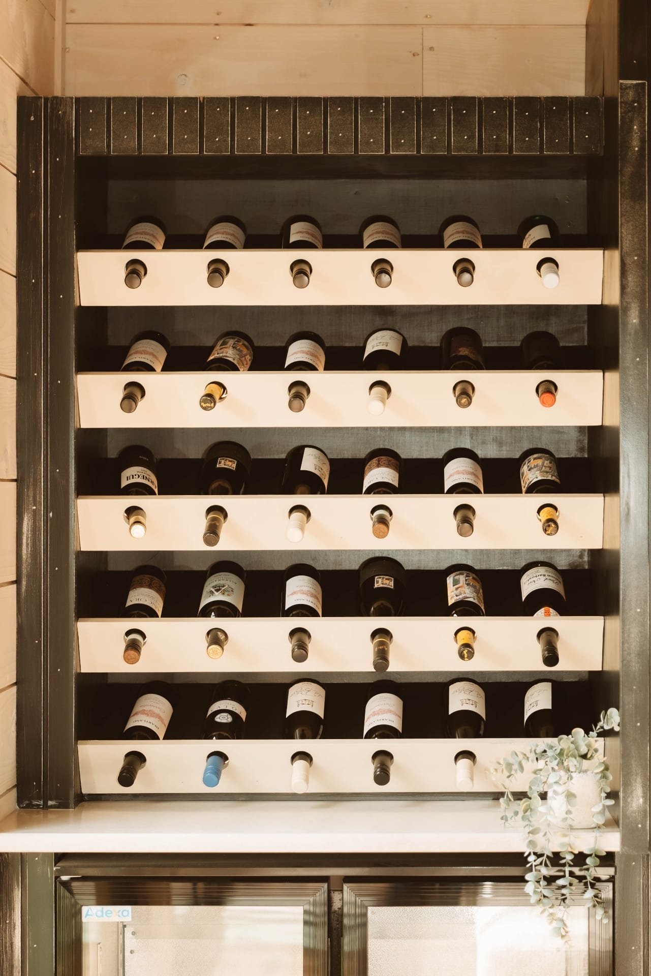 Treehouse Lookout built-in wine wall beside the lounge fireplace
