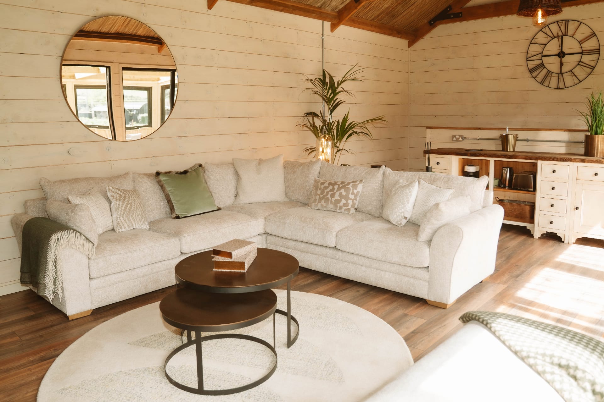 Treehouse Lookout open lounge with sectional sofa, coffee table and kitchenette