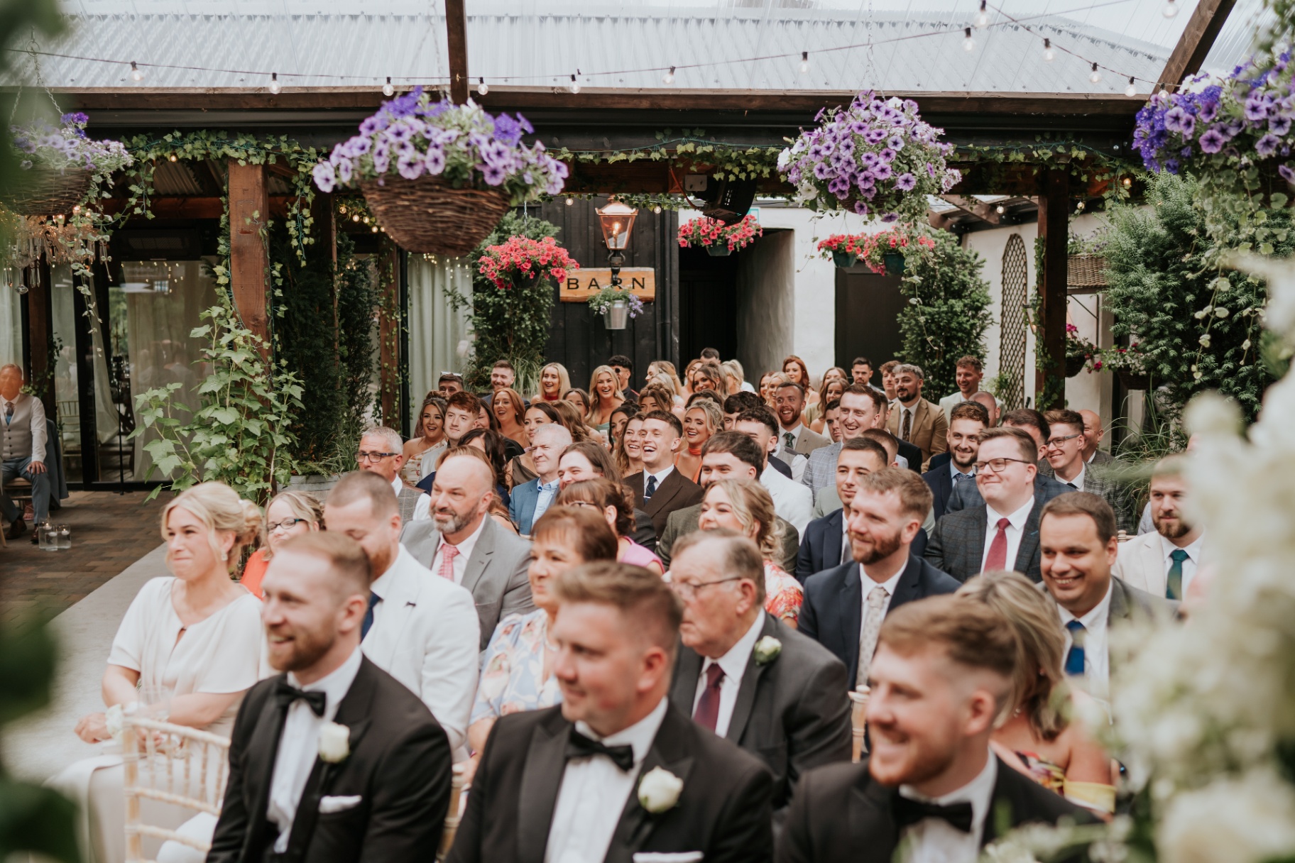 Guests gathered for the ceremony with the Barn doorway behind
