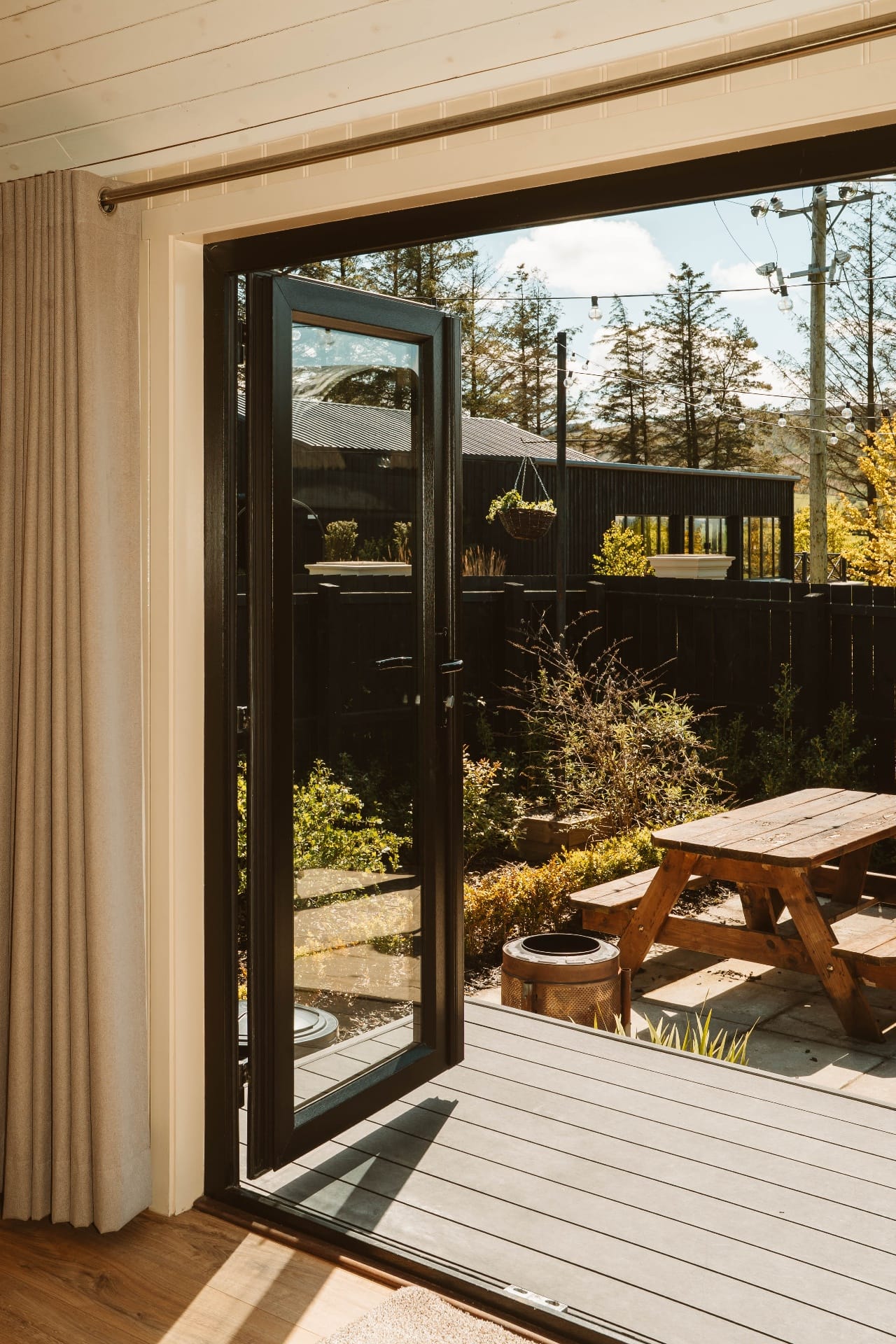 Shepherd's Hut deck with picnic bench seen through open doors