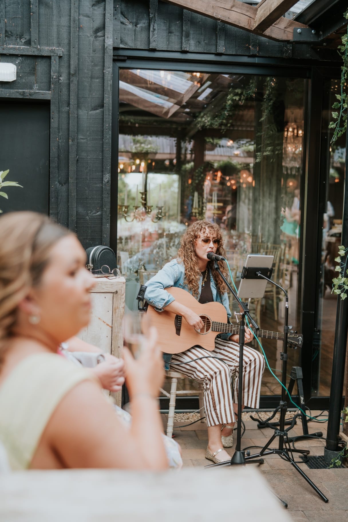 Wedding guest watching the courtyard acoustic set