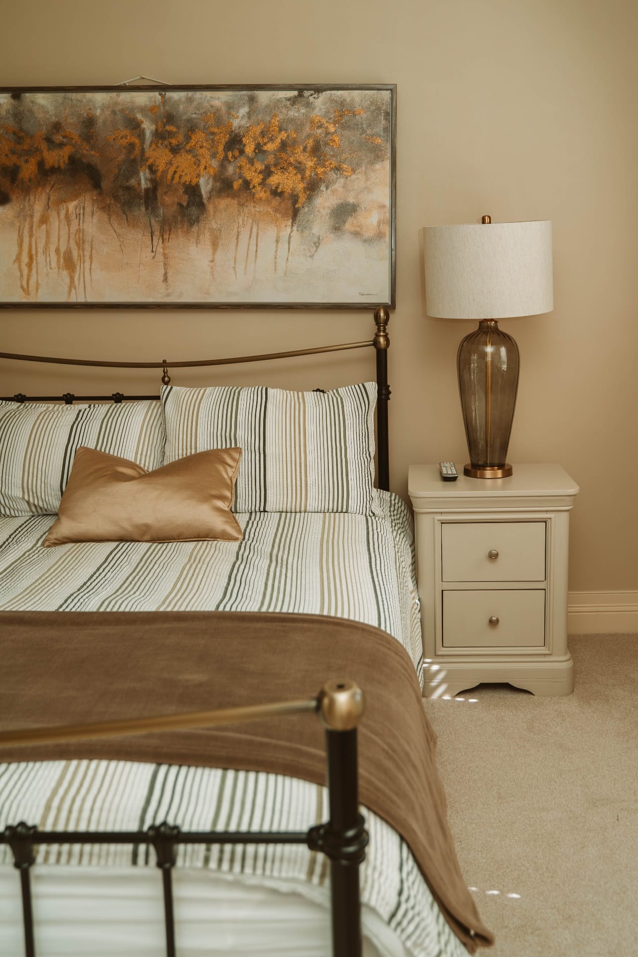 Farmhouse bedside detail with glass lamp and artwork