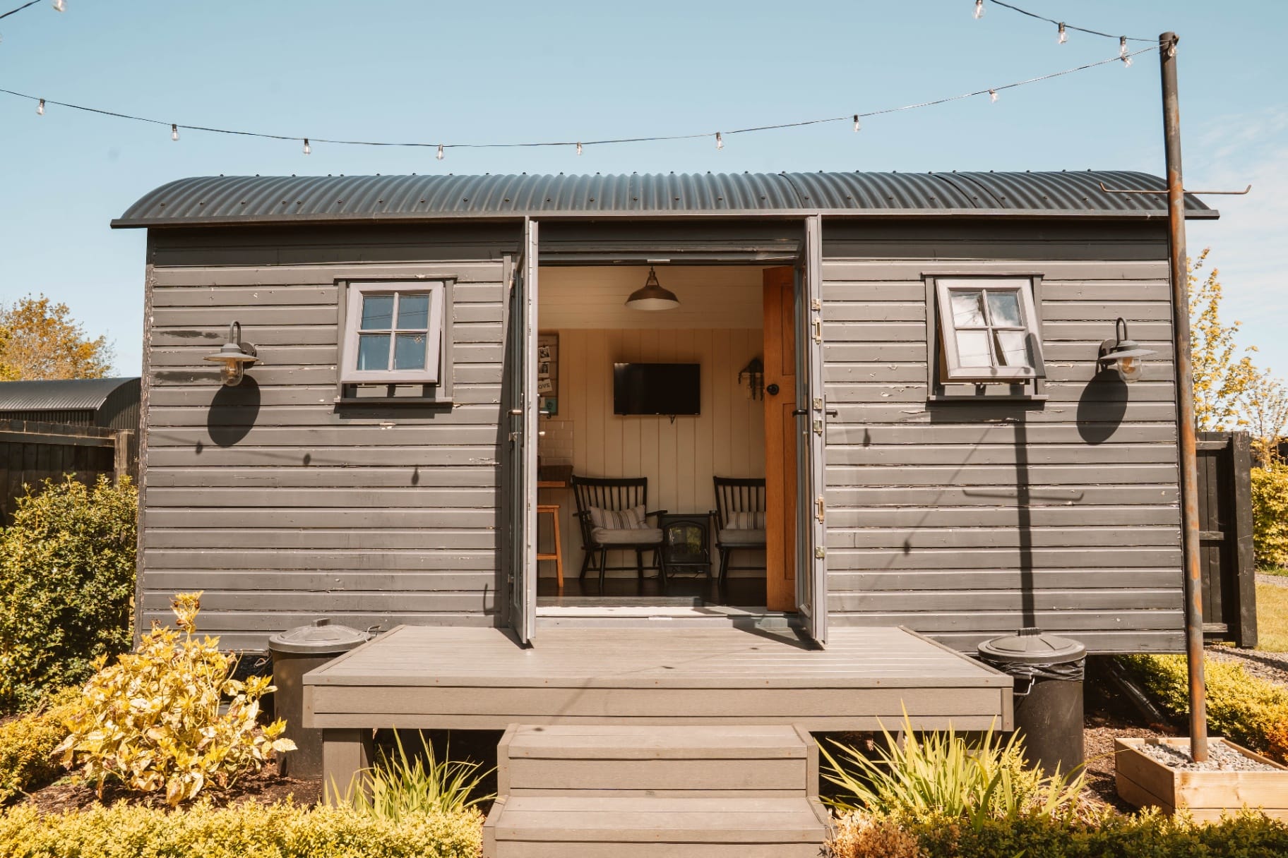 Front-on Shepherd's Hut exterior with open doors and deck