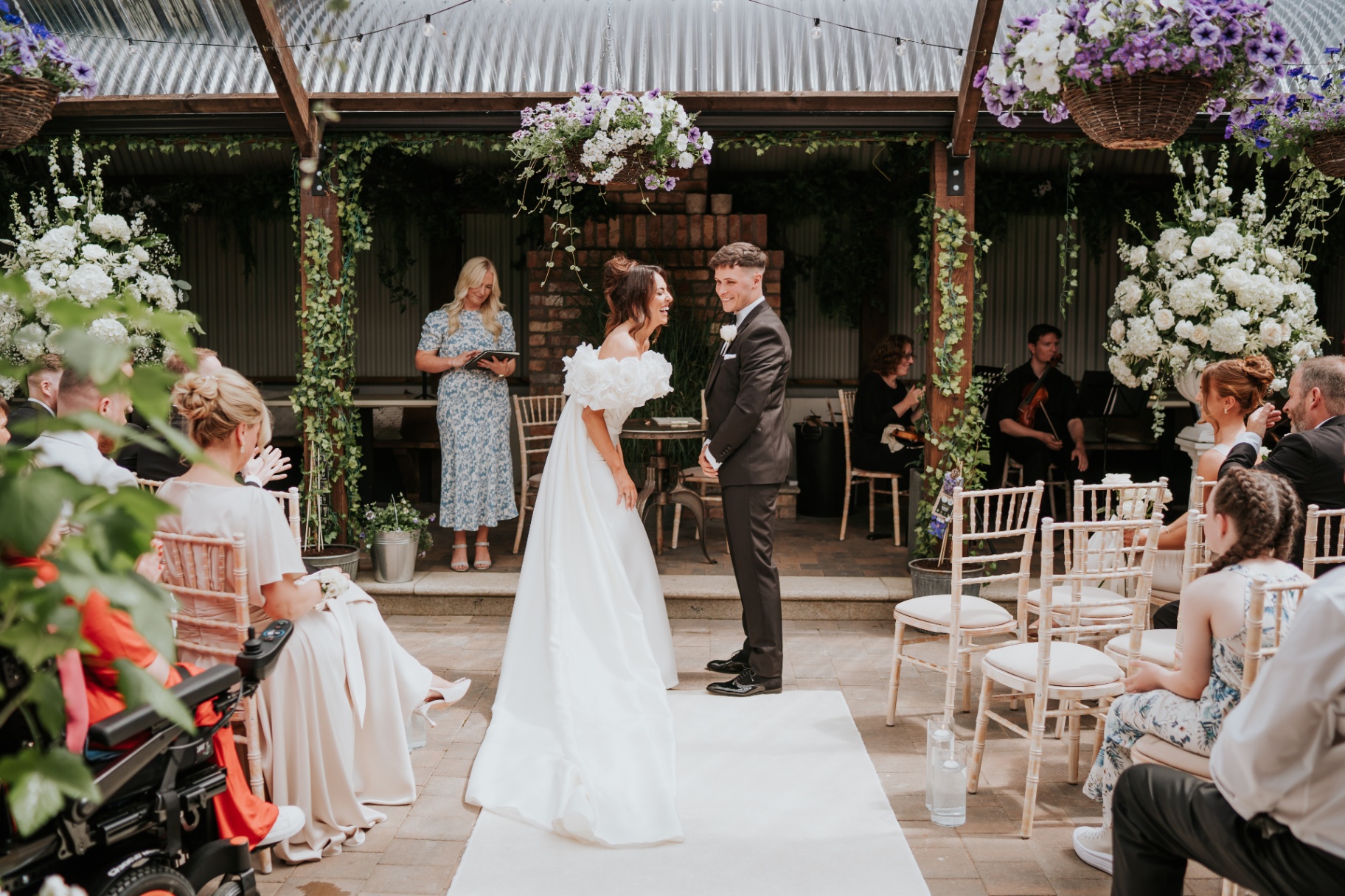 The couple laughing together at the altar
