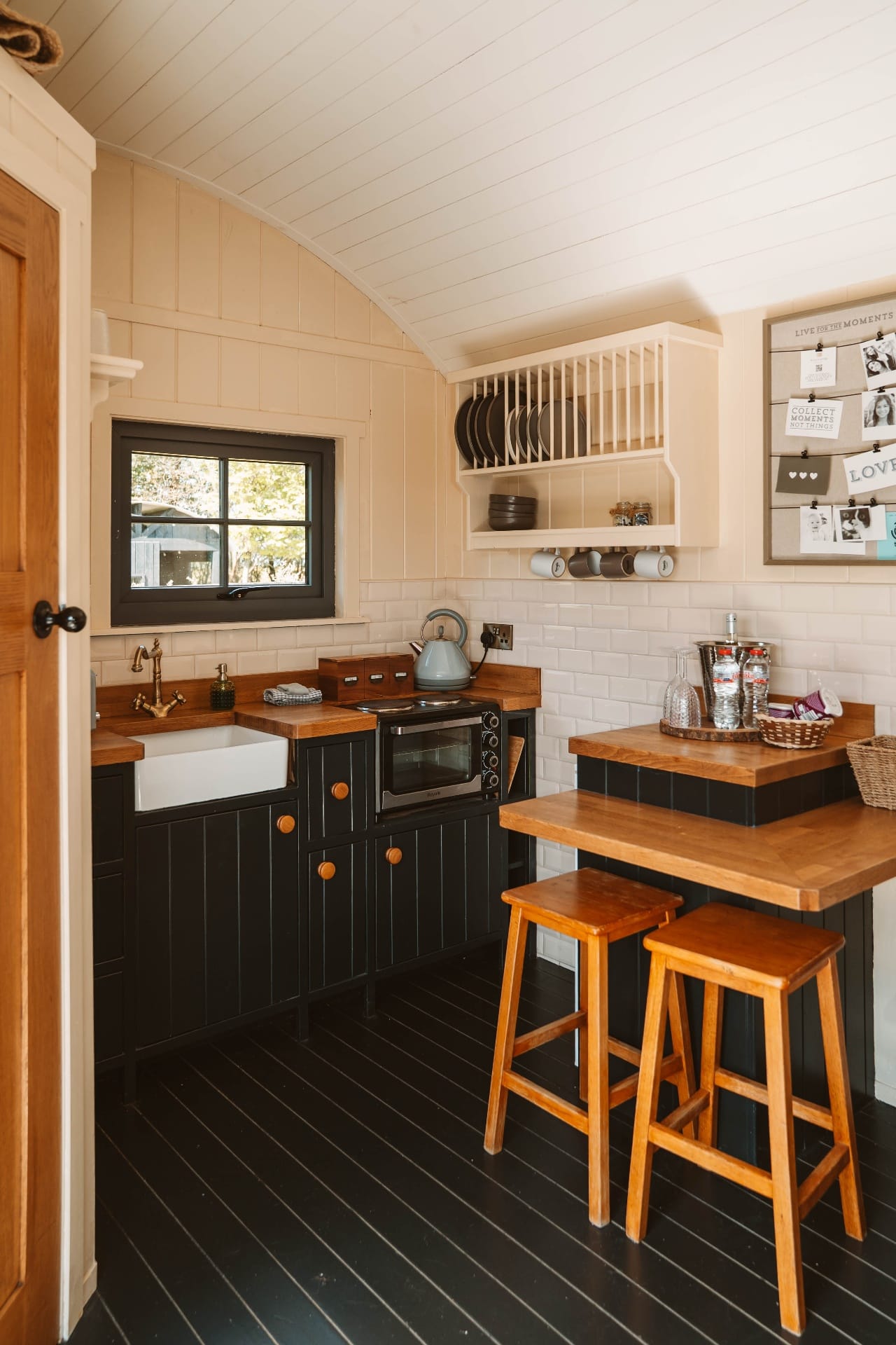 Shepherd's Hut kitchen corner with Belfast sink and breakfast stools