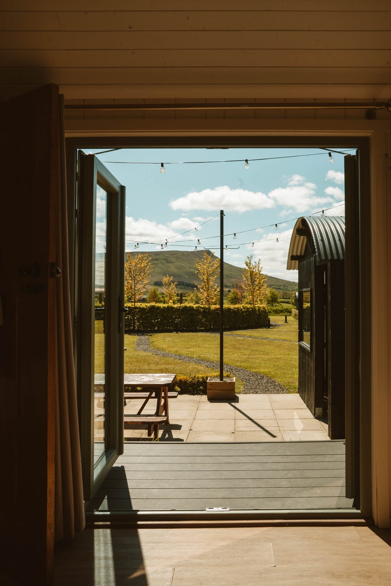 Open Shepherd's Hut doorway framing Ballyness mountain views