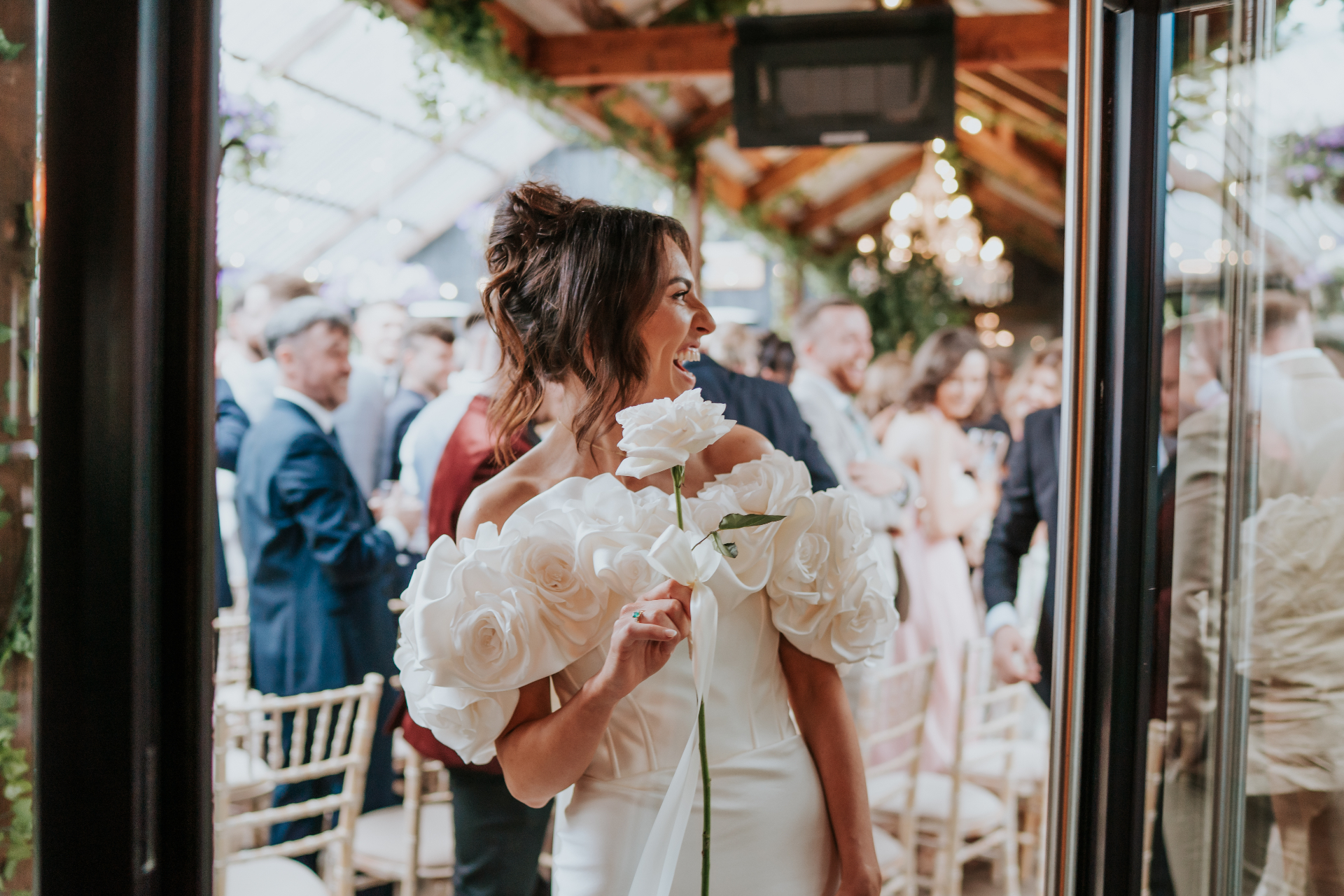 Bride laughing as she steps through the Barn doors after the ceremony
