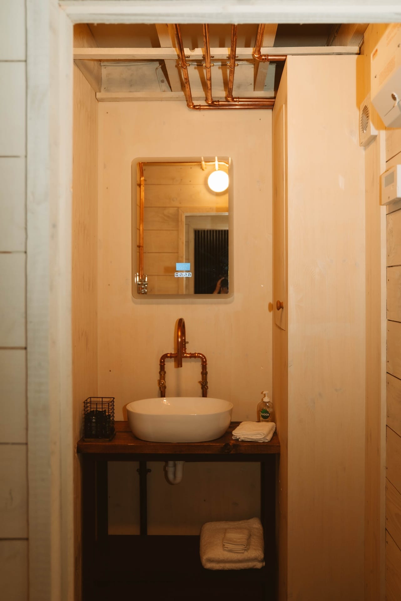 Treehouse Lookout bathroom with copper tap and mirror over wooden vanity