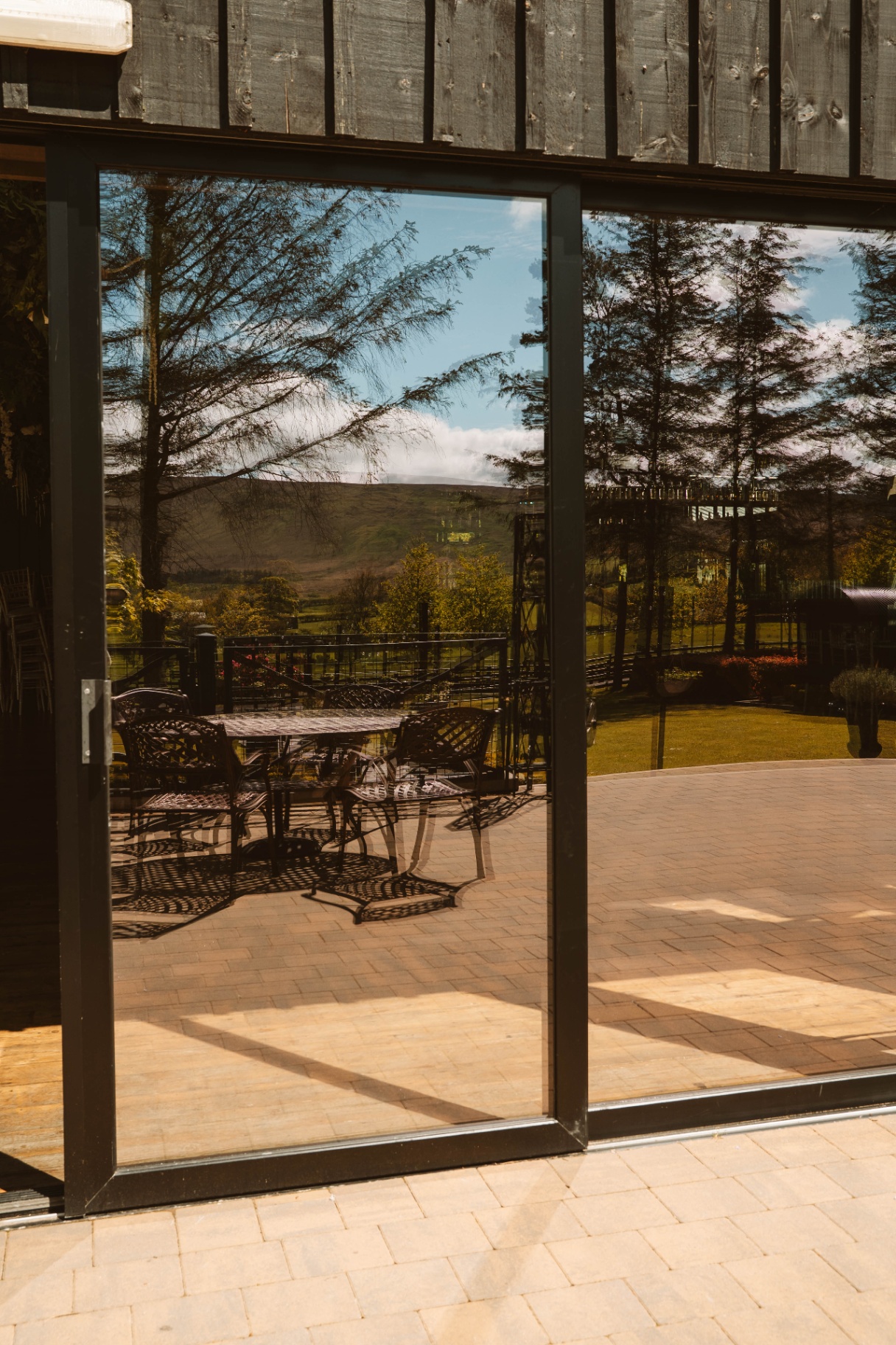 Patio table and chairs framed by the Courtyard's black sliding doors