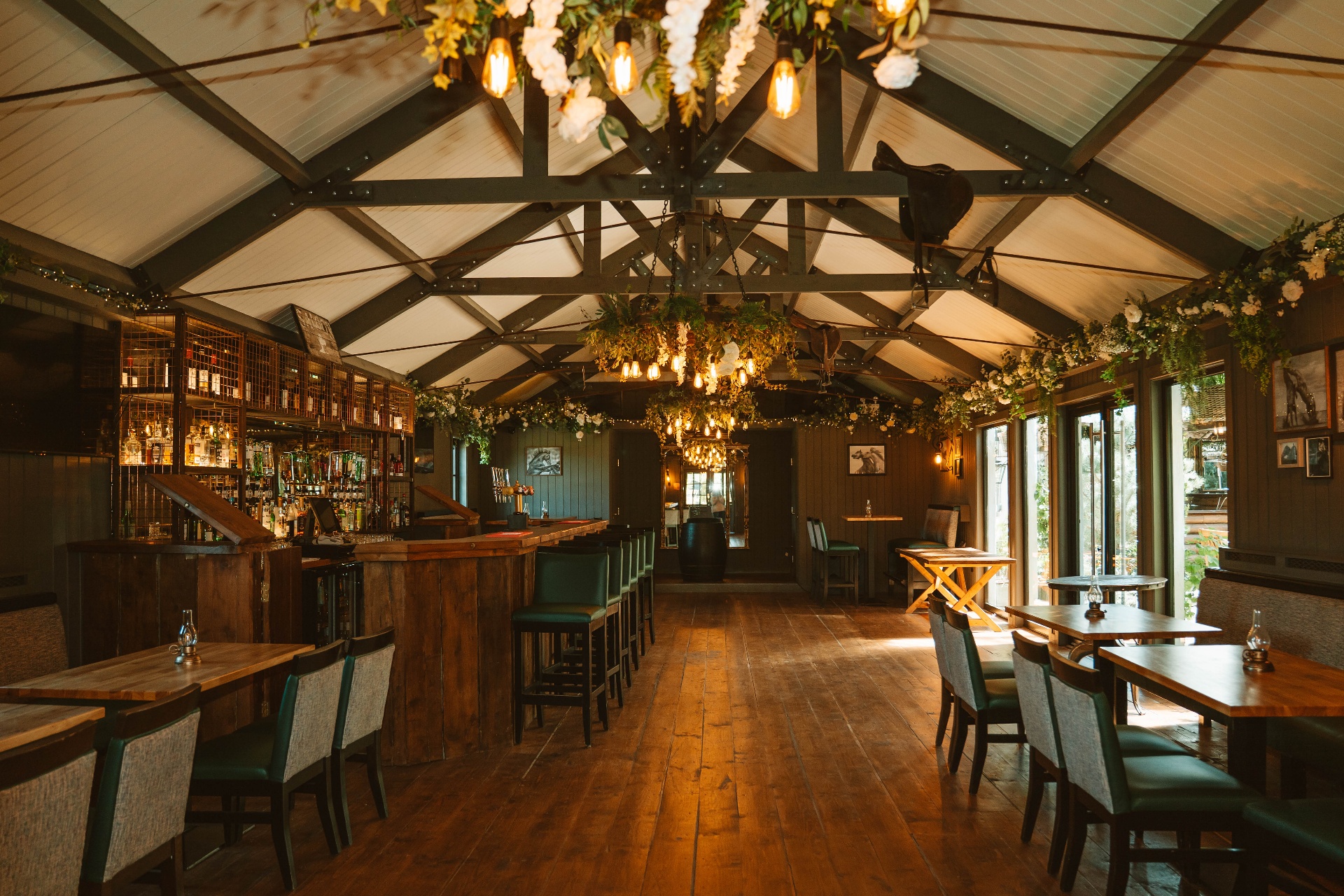 The Grange interior with vaulted beams and floral chandeliers