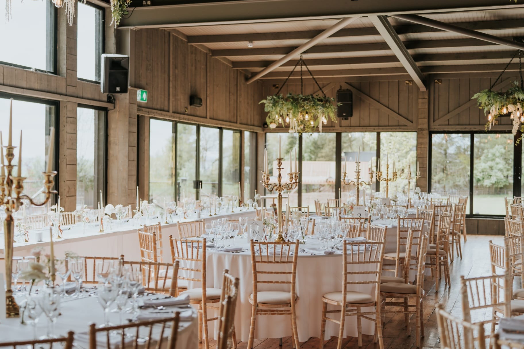 The Barn dressed for a wedding reception with chiavari chairs