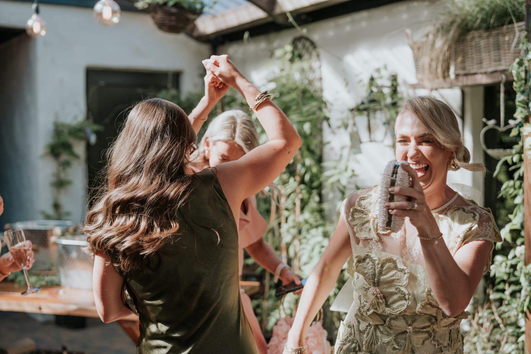 Bride laughing with guests dancing in the courtyard at Ballyness