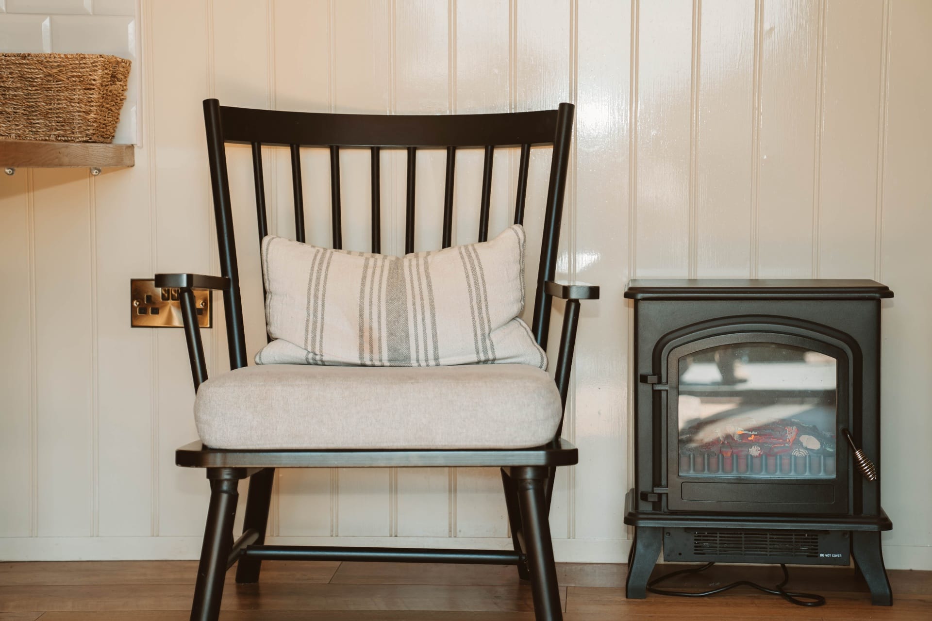 Shepherd's Hut fireside chair beside the log burner