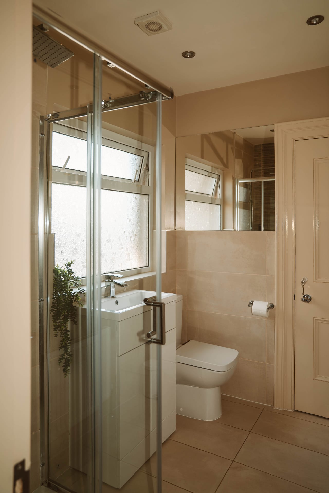 Farmhouse bathroom with frosted window and glass shower