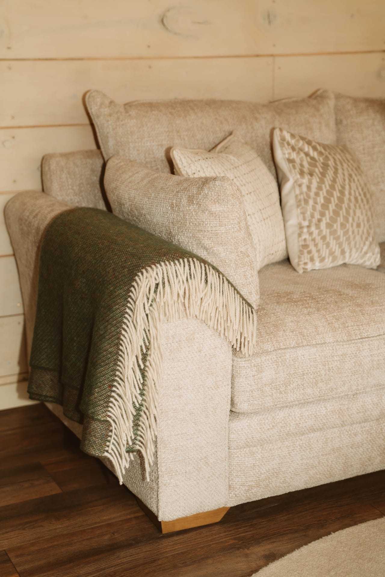 Treehouse Lookout lounge armchair with textured cushions and green throw