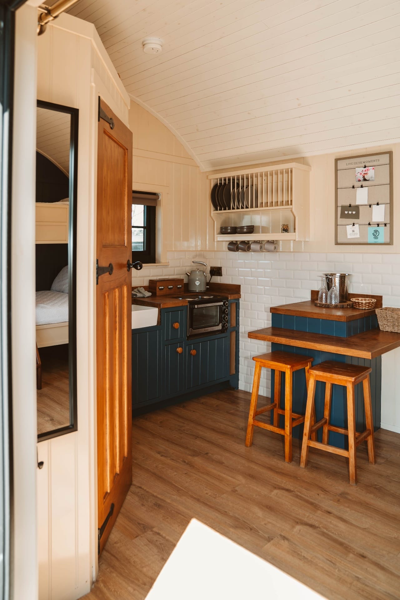 Shepherd's Hut kitchen view through doorway with bunk room beyond