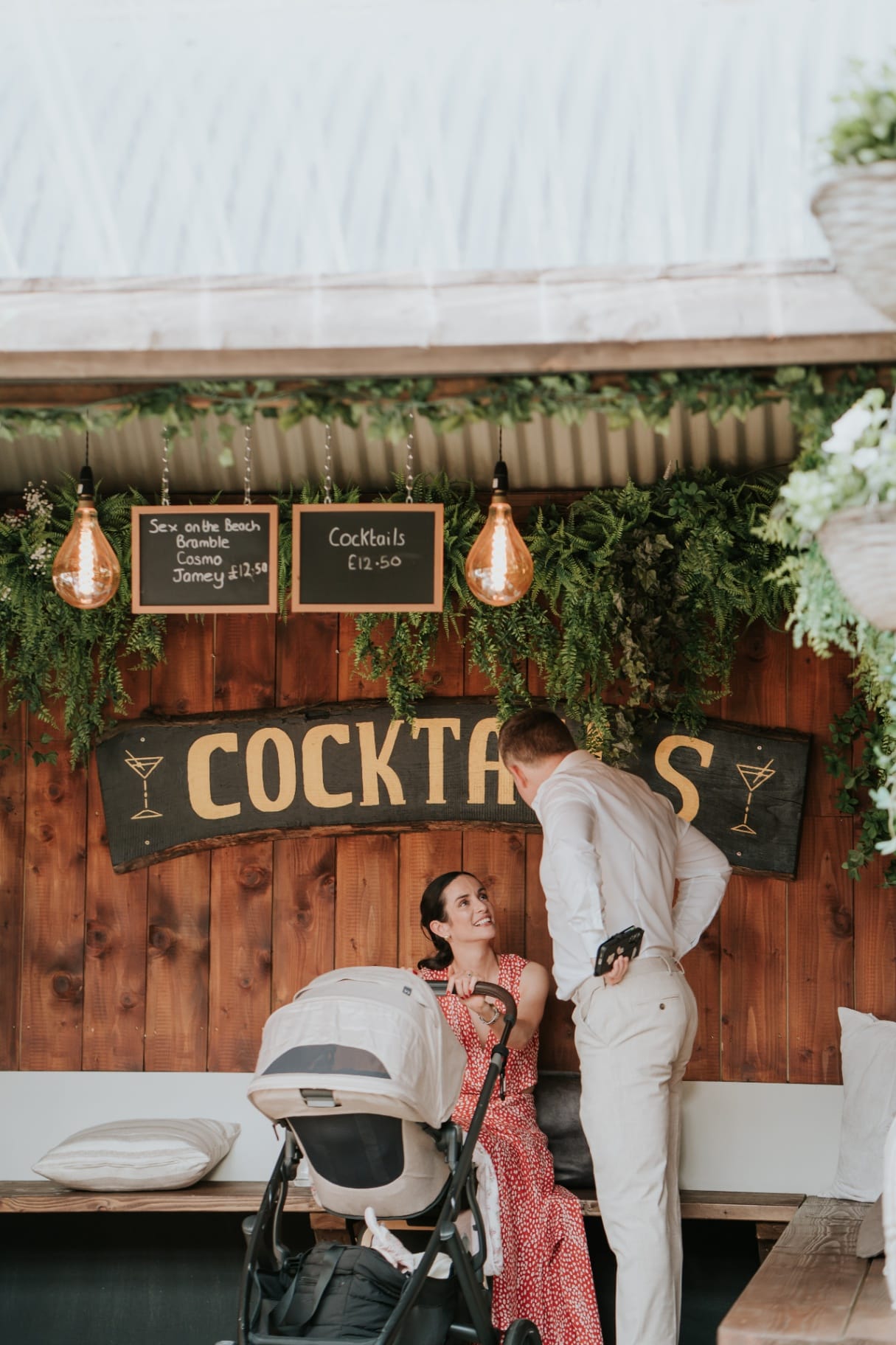 Cocktail bar sign with hanging greenery inside the Ballyness courtyard