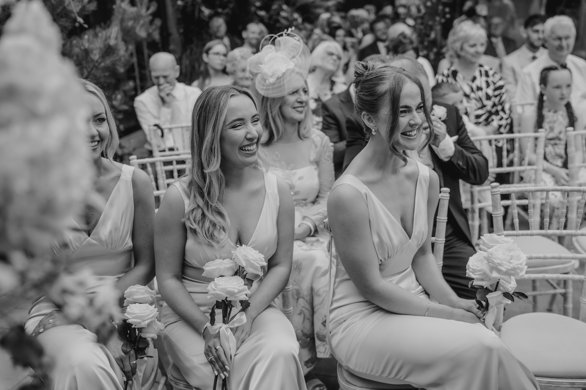 Bridesmaids laughing during the ceremony