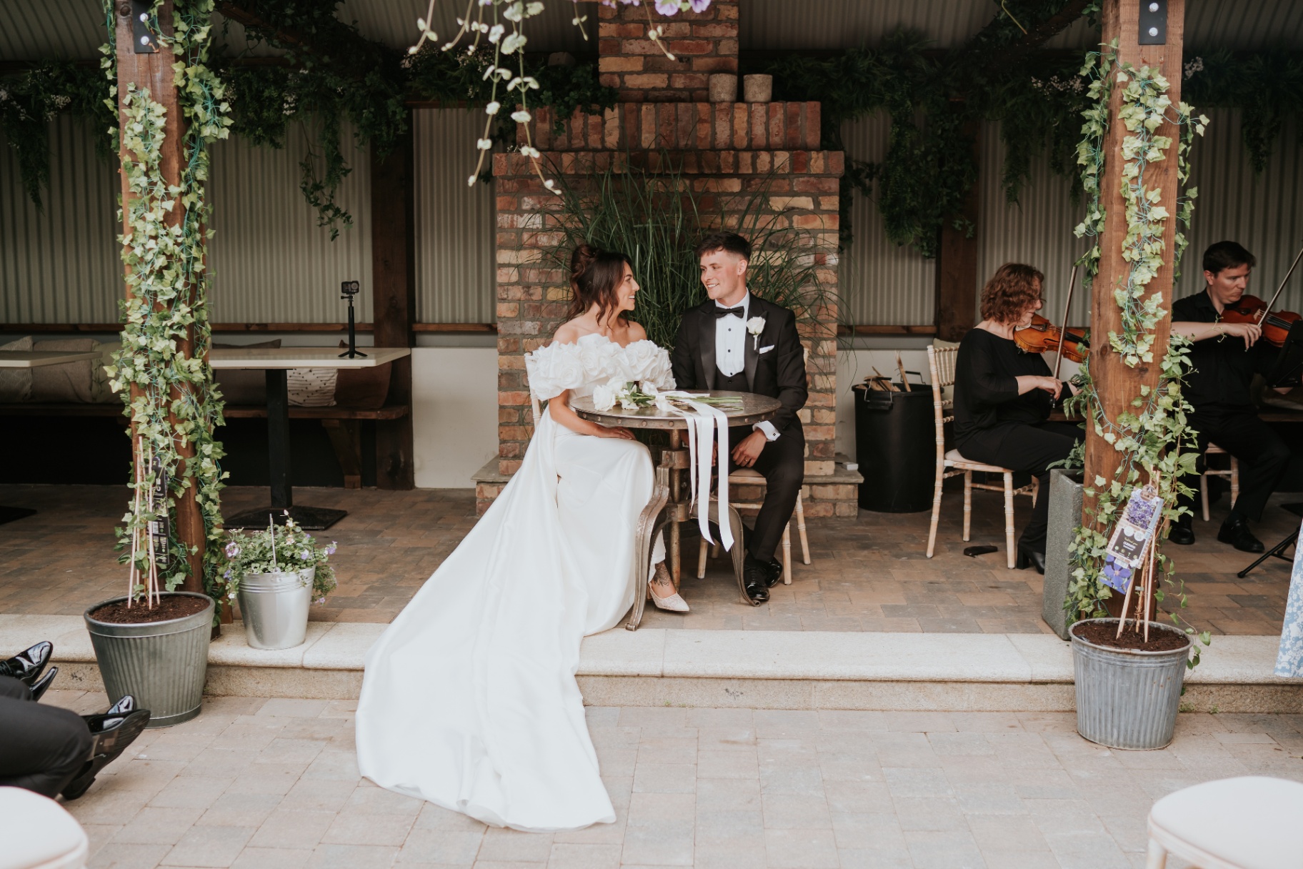 Signing the register with a string duo playing alongside