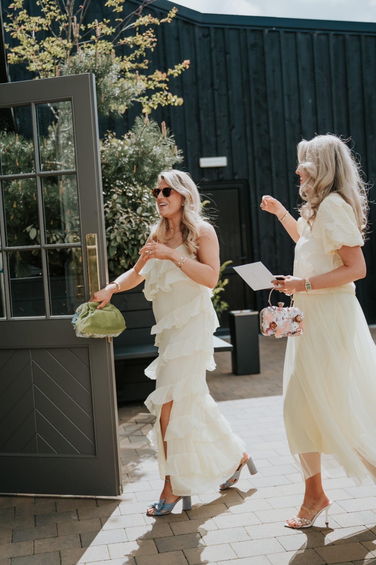 Wedding guests arriving through the Stables courtyard doors