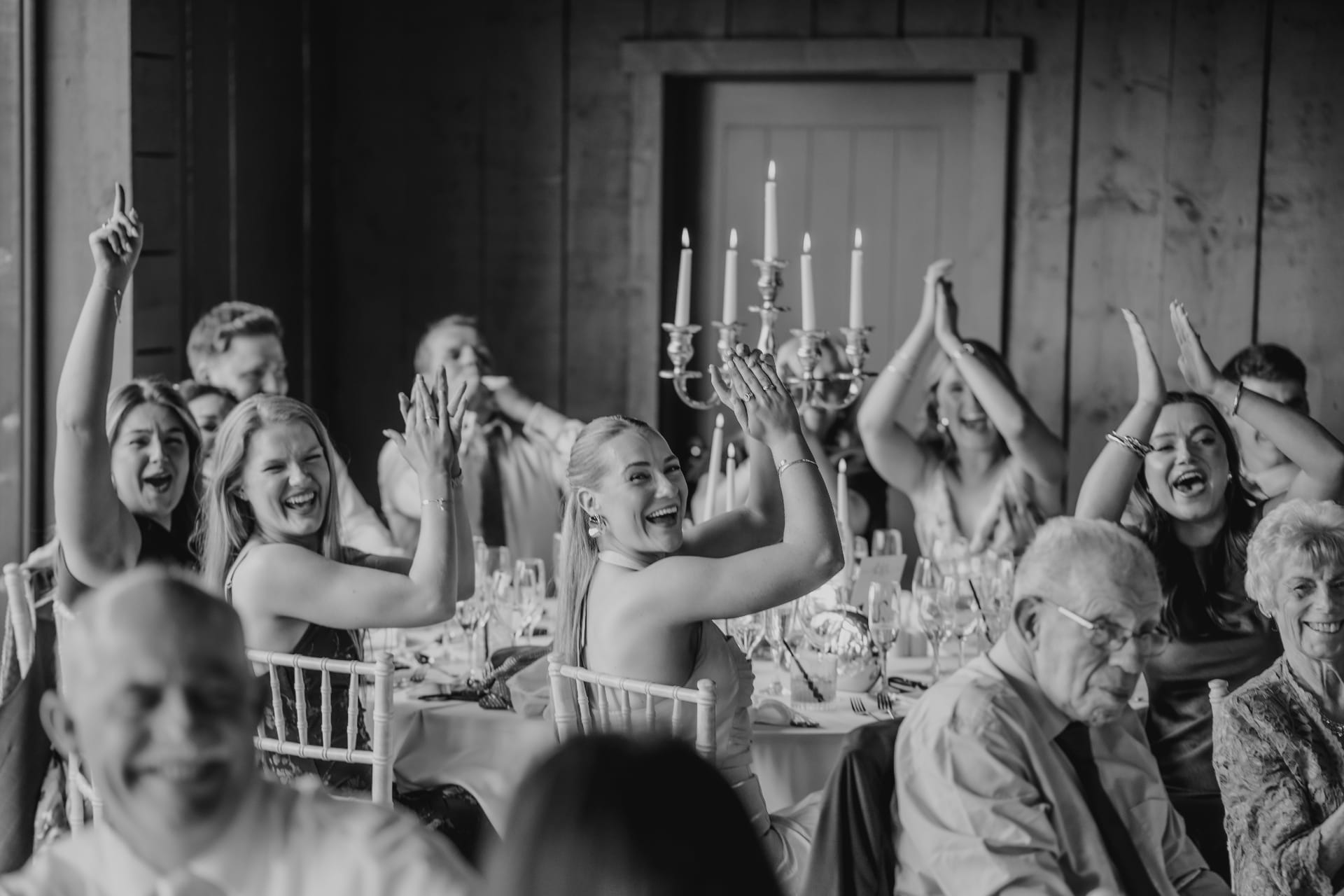 Guests cheering and clapping during the Ballyness wedding reception in black and white