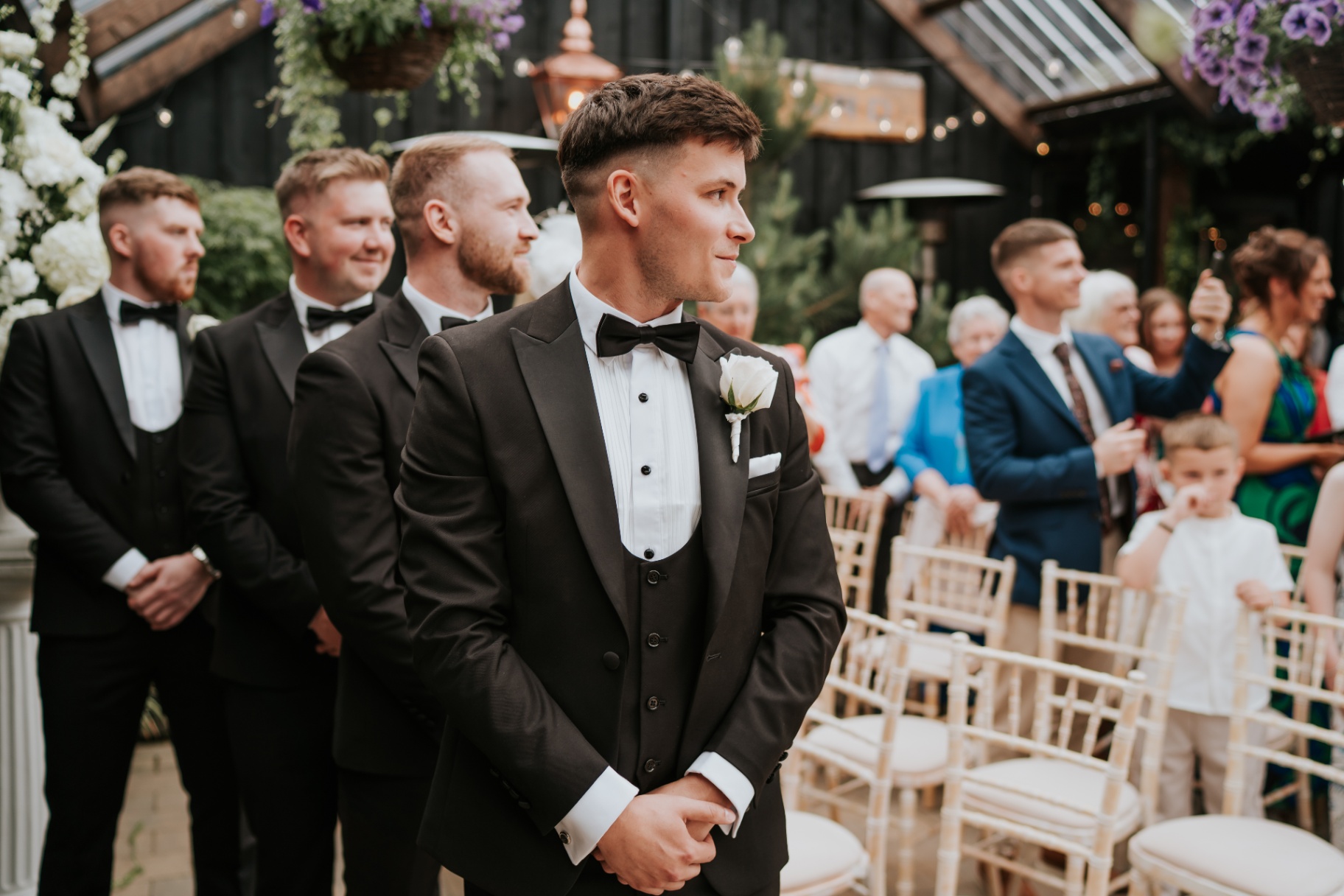 Groom waiting at the altar with his groomsmen