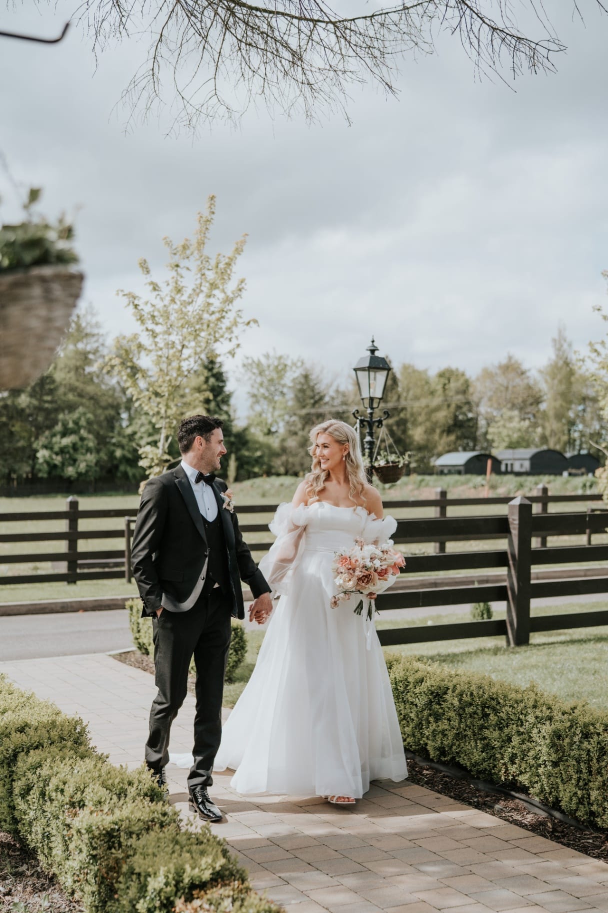 Bride and groom walking through the courtyard gardens