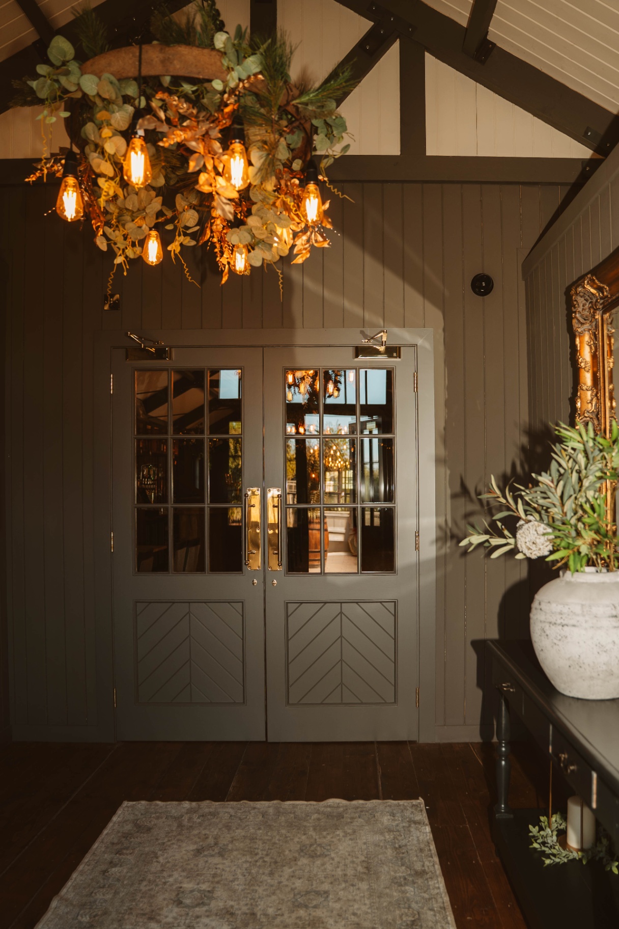 Grand double doors leading through to the Tack Room bar under an autumn wreath