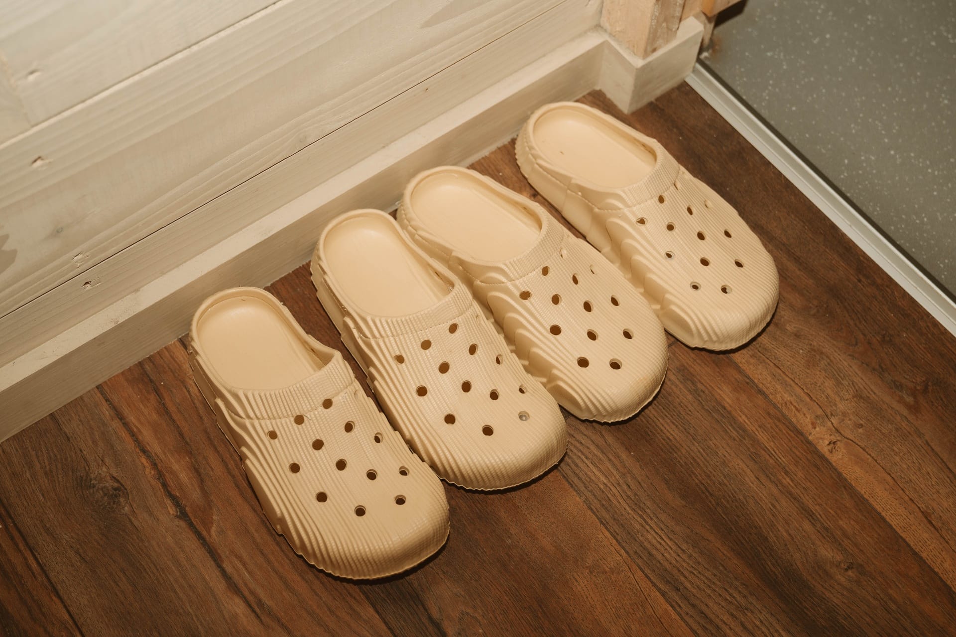 Treehouse Lookout guest slippers lined up by the door on dark timber floor