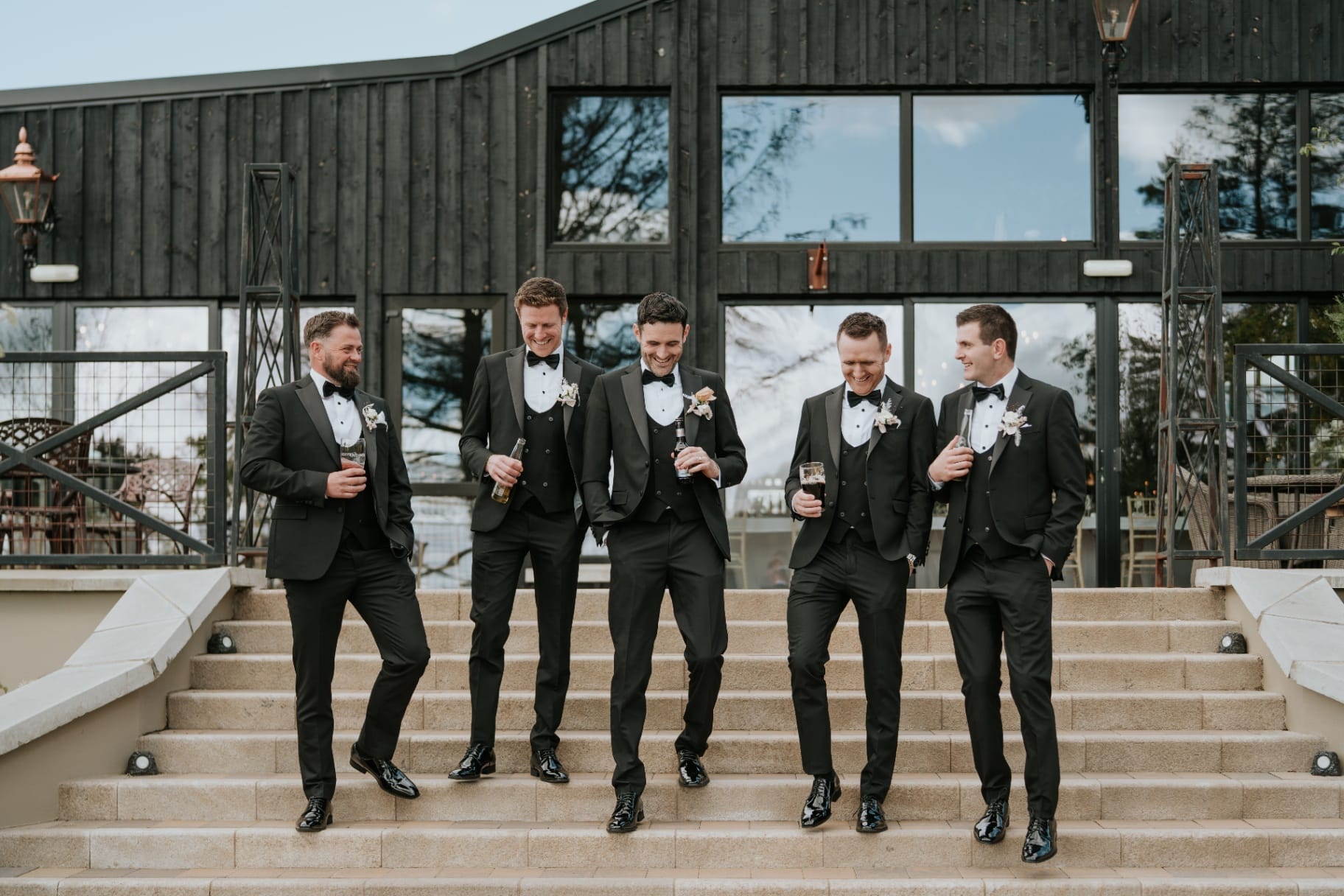Groomsmen walking down the Ballyness steps outside The Barn