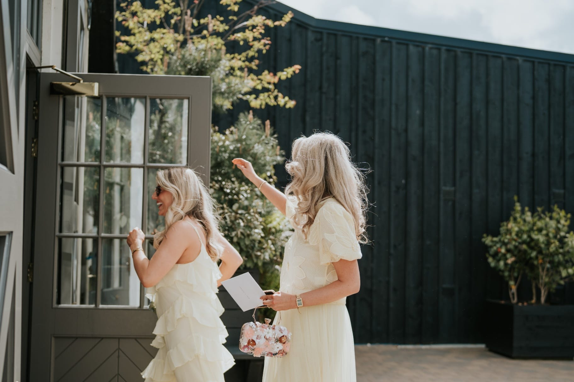 Guests entering the Stables courtyard in soft sunshine